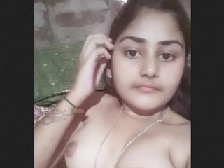 A seductive teen caressing her smooth lower lip