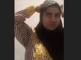 A young woman from India in a hijab plays coyly and displays herself