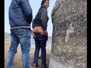 A bold pair discovered engaging in intimate acts by the water's edge