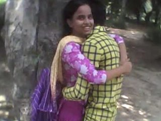 Passionate couple engages in open-air romance