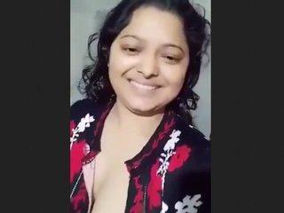 A married woman from Bangladesh with large breasts pleases her husband by posing for him
