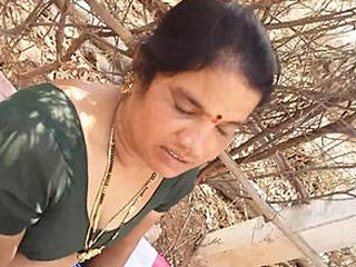 A mature Indian woman gives oral pleasure while her breasts are fondled