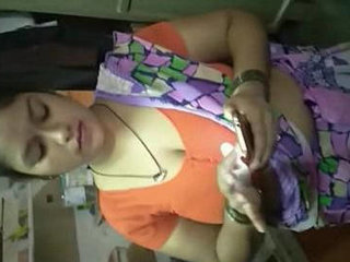 Janaki, a sultry housewife, seductively displays her ample bosom in a saree