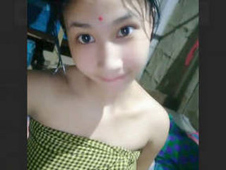 A pretty Assam wife undresses for a nude selfie