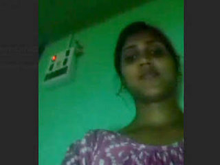 A young Indian woman stimulates her moist vagina with her fingers