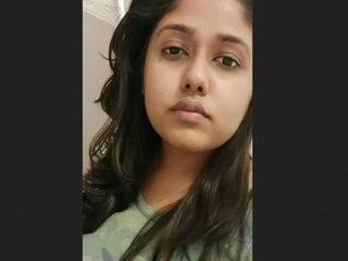 A charming Indian girlfriend takes a selfie while in bed