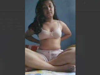 A stunning and adorable girl displays and stimulates her vagina with her fingers