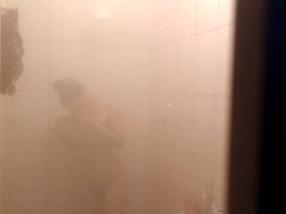 Filming my attractive relative as she enjoys a steamy shower