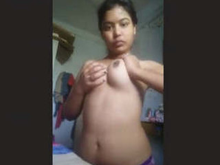 A stunning woman flaunts her ample bosom in a captivating performance.