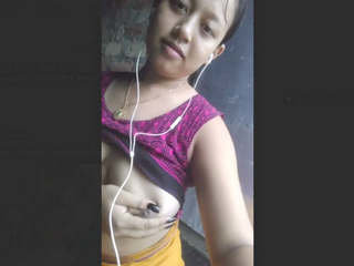 A lovely girl indulging in self-pleasure with her breasts