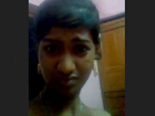 Attractive woman displays breasts and genitals in a live performance