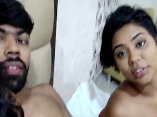 Two girls give a handjob and blowjob in a threesome