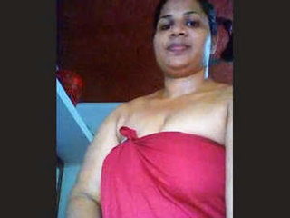 Big-breasted Malayalam bhabhi strips and teases in a video