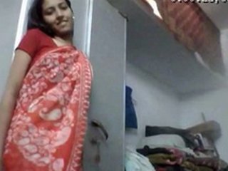 A young and eager girl in a saree performs a striptease for money